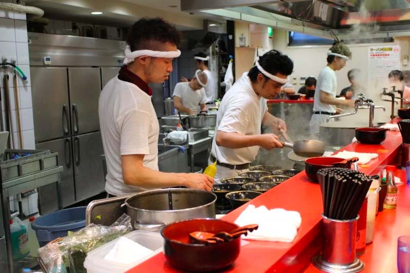 Traditional Japanese ramen ingredients, including noodles, broth, and garnishes